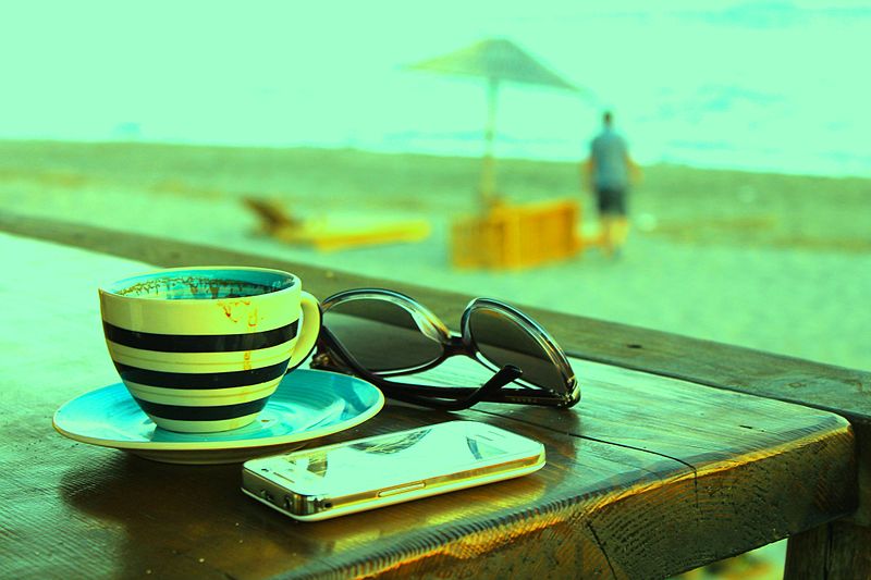 Beach photo with phone, coffee and sunglasses